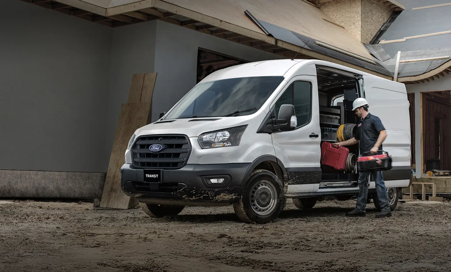 A construction worker putting their tools in a Ford Transit