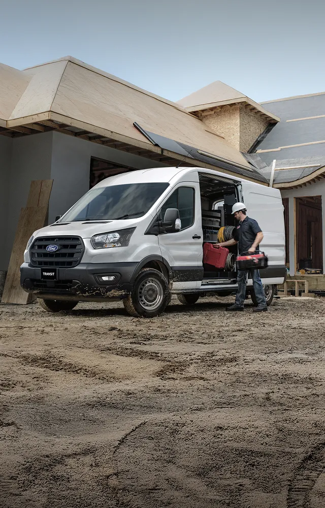 A construction worker putting their tools in a Ford Transit