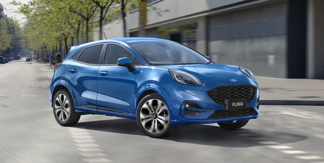 New Ford Puma turning left on a road in the city