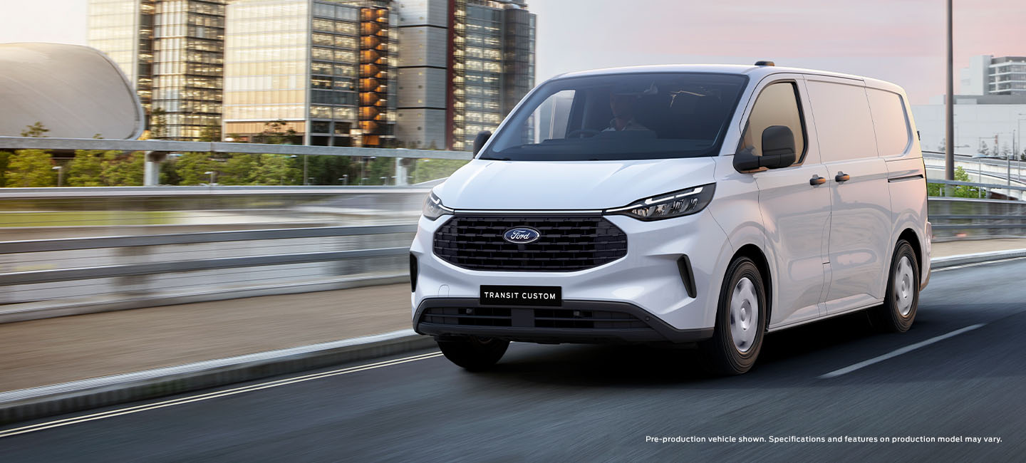 Next-Gen Transit Custom Van Driving Down City Road