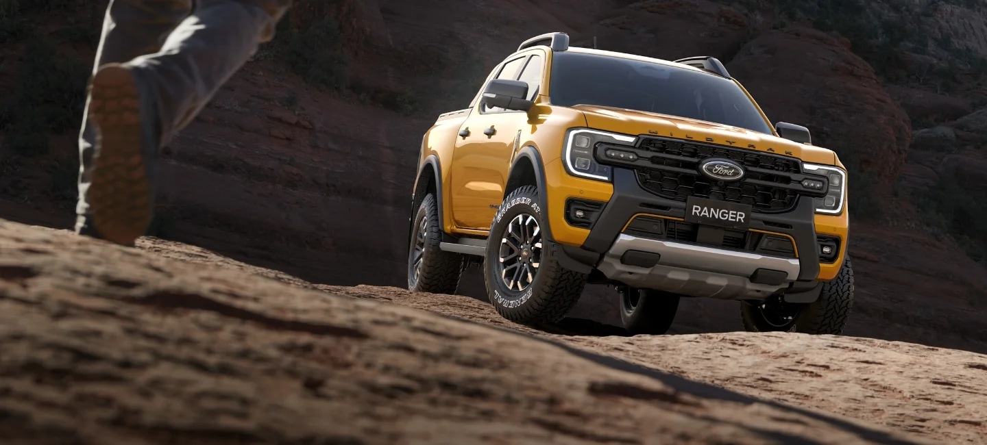 Ford Ranger Wildtrak X driving through countryside landscape 