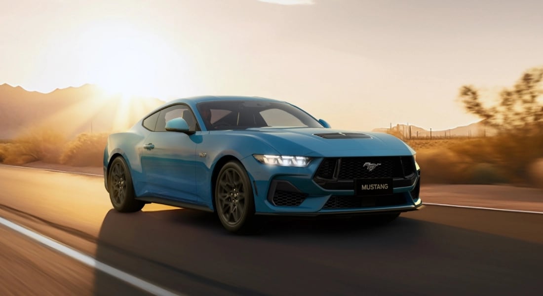 Ford Mustang driving on countryside road