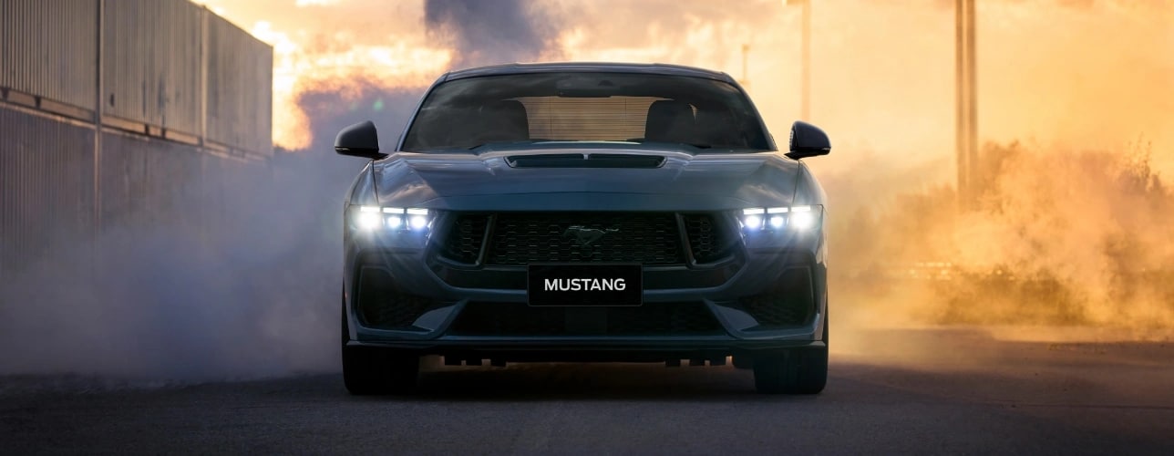Ford Mustang with smoke and fire in the background