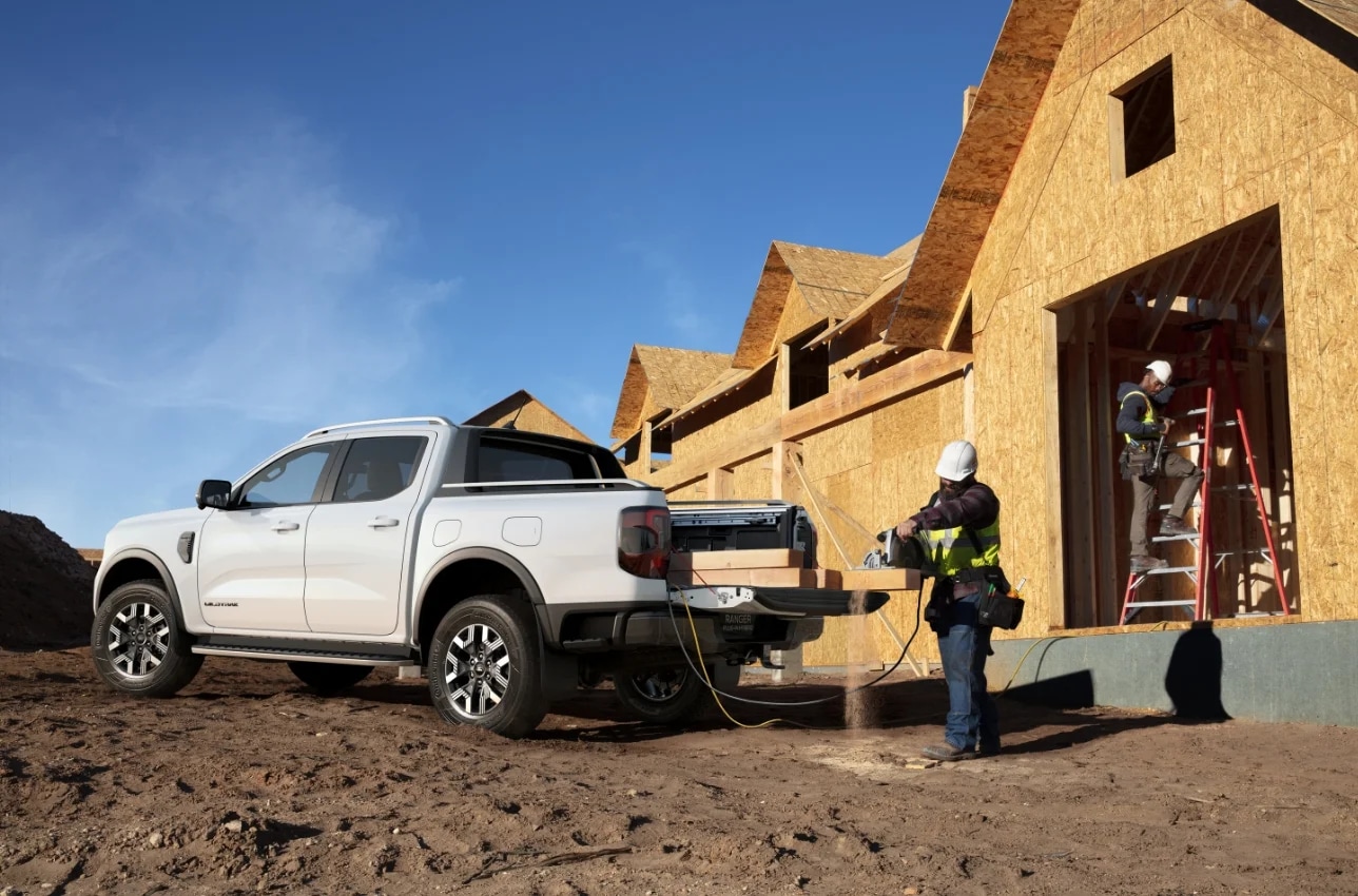 Ford Ranger being loaded by the tradies with wooden beams at a construction site.