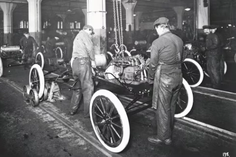 two people working on car engine on static