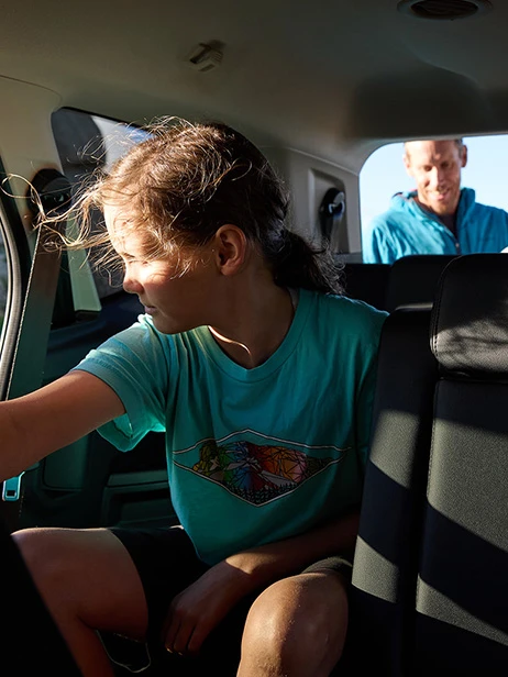 Child gazing from SUV