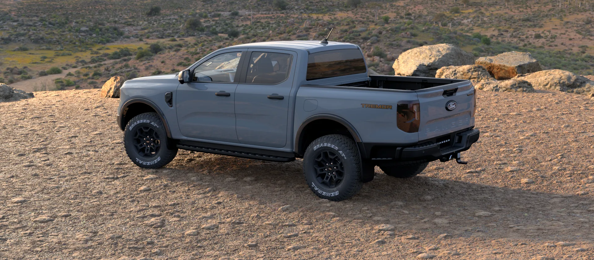 Ford Ranger Tremor grey rear side view off-road.