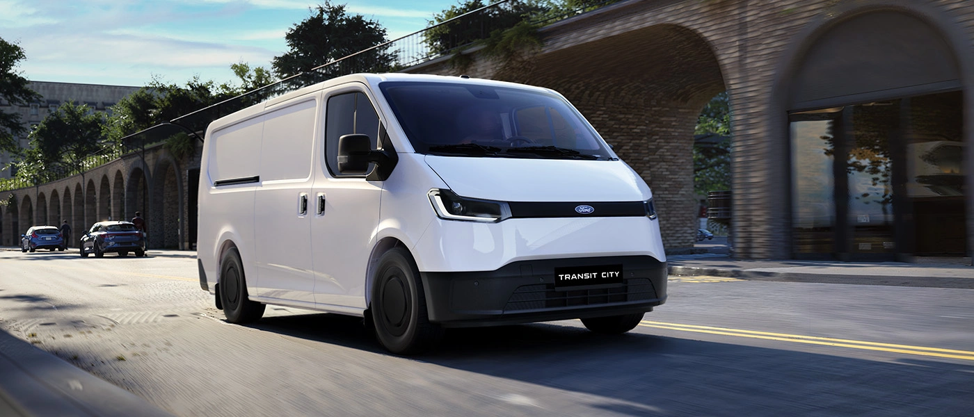 White Ford van driving street.