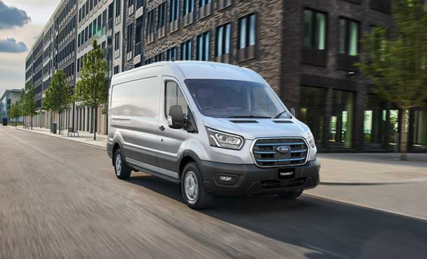 Silver Ford E-Transit driving on the road in the city